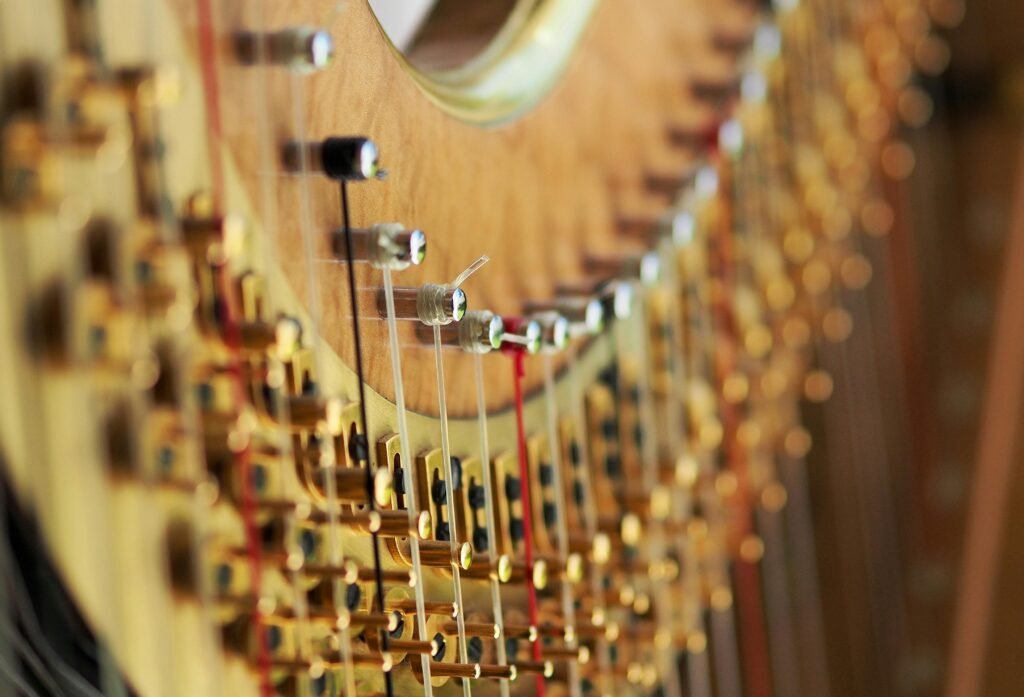 pexels-photo-237454-237454 A close-up view of a harp showcasing its intricate strings and tuning pegs in fine detail.